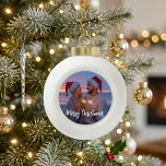 Festive Christmas Photo Design with Script Greetin Ceramic Ball Christmas Ornament<br><div class="desc">This festive Christmas photo design features a circular image area with elegant script lettering for a warm seasonal look. The soft sparkler glow, Santa hats, and cozy winter mood make the layout feel personal and memorable without overwhelming the photo. It works well for a couple portrait, family snapshot, or another...</div>