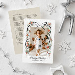 Festive Christmas Ribbon with Poinsettias Holiday Card<br><div class="desc">Send you family and friends a family update and message of holiday cheer with this one-photo Christmas card featuring sweet, hand-drawn illustrations of a black ribbon accented with festive sprigs of red poinsettia flowers and greenery. Traditional fonts keep the feeling high end and traditional making this holiday card an excellent...</div>