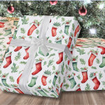 Festive Red Green Stockings Christmas Wrapping Paper<br><div class="desc">Add a touch of festive elegance to your holiday gifts with this wrapping paper featuring a Christmas stocking and holly leaf pattern in green and red against a white background. You can customize the background to any color to match your holiday theme. This design brings joy to your Christmas presents...</div>