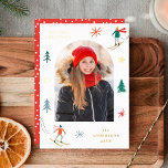 Festive Skiers Photo Foil Holiday Card<br><div class="desc">Festive foil holiday card featuring your arched photo surrounded by colorful skiers, gold foil stars, and pine trees. Personalize the front of the photo Christmas card with your custom greeting (currently shown as "Merriest Christmas"), family name, and year in gold foil lettering. The ski-themed holiday card reverses to a red...</div>