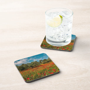 field with flowers and trees beverage coaster