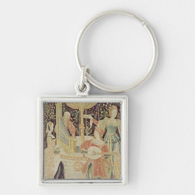 Figures around a fountain keychain (Front)