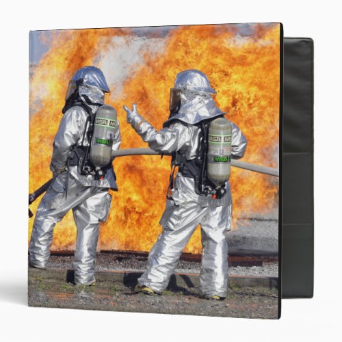 Firefighters battle a simulated fire binder