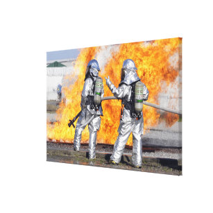 Firefighters battle a simulated fire canvas print