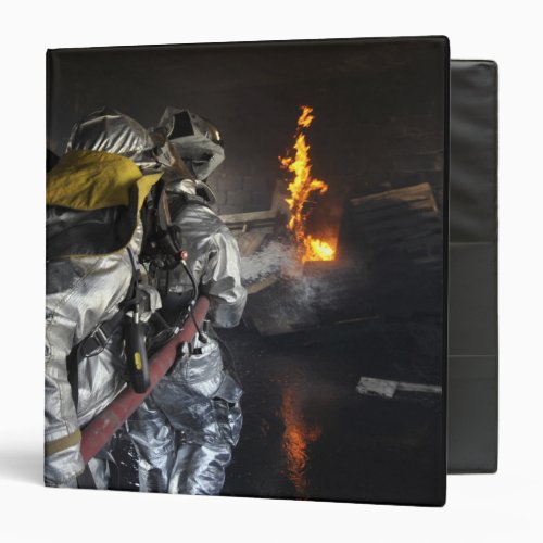 Firefighters extinguish a fire in a training ro 3 ring binder