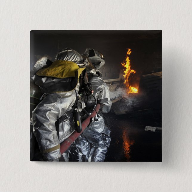 Firefighters extinguish a fire in a training ro pinback button (Front)