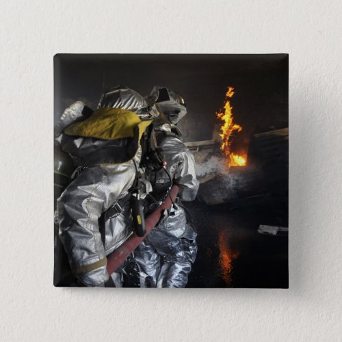 Firefighters extinguish a fire in a training ro pinback button