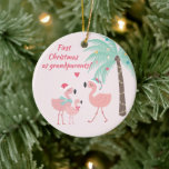 First Christmas as Grandparent Cute Santa Flamingo Ceramic Ornament<br><div class="desc">NewParkLane - Christmas Ornament for new grandparents, featuring a tropical scene with two cute pink flamingos wearing a Santa hat and a baby flamingo, and a decorated palmtree. With Quote: 'First Christmas as grandparents' in raspberry pink. All text styles, colors, and sizes can be modified to fit your needs. A...</div>