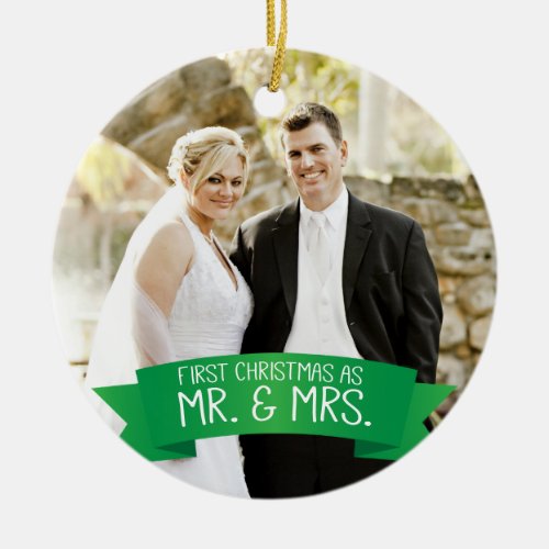 First Christmas as Mr. & Mrs. Photo Green Ceramic Ornament - This photo Christmas tree ornament features photo frame to fill the front of the ornament. A graphic of a green ribbon banner, near the bottom, features the text: First Christmas as Mr. & Mrs. Custom text, on the back, allows you to add the names of the bride and groom and the year. This ornament is a perfect Christmas gift for the newlyweds.