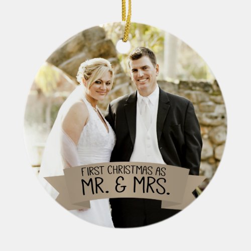 First Christmas as Mr. & Mrs. Photo Tan Ceramic Ornament - This photo Christmas tree ornament features photo frame to fill the front of the ornament. A graphic of a tan ribbon banner, near the bottom, features the text: First Christmas as Mr. & Mrs. Custom text, on the back, allows you to add the names of the bride and groom and the year. This ornament is a perfect Christmas gift for the newlyweds.