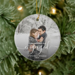 First Christmas Engaged 2-Photo White Script Ceramic Ornament<br><div class="desc">Commemorate your engagement with this beautiful modern keepsake ornament. The white text on the front reads "Our first Christmas engaged, " with the word "engaged" in elegant handwriting script with flourishes before and after; add your names and the year. A dark gradient filter helps make the text pop. Replace the...</div>