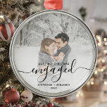 First Christmas Engaged Custom Photo Black Script Metal Ornament<br><div class="desc">Commemorate your engagement with this beautiful modern keepsake ornament. The black text reads "Our first Christmas engaged, " with the word "engaged" in elegant handwriting script with flourishes before and after. Replace the sample image with your favorite photo, and add your names and the year. A white gradient filter helps...</div>