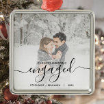 First Christmas Engaged Custom Photo Black Script Metal Ornament<br><div class="desc">Commemorate your engagement with this beautiful modern keepsake ornament. The black text reads "Our first Christmas engaged, " with the word "engaged" in elegant handwriting script with flourishes before and after. Replace the sample image with your favorite photo, and add your names and the year. A white gradient filter helps...</div>