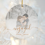 First Christmas Engaged Custom Photo Copper Script Ceramic Ornament<br><div class="desc">Commemorate your engagement with this beautiful modern keepsake ornament. The copper-colored text reads "Our first Christmas engaged, " with the word "engaged" in elegant faux foil handwriting script with flourishes before and after. Replace the sample image with your favorite photo, and add your names and the year. A white gradient...</div>