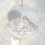 First Christmas Engaged Custom Photo Gray Script Ceramic Ornament<br><div class="desc">Commemorate your engagement with this beautiful modern keepsake ornament. The charcoal gray text reads "Our first Christmas engaged, " with the word "engaged" in elegant script with swashes before and after. Replace the sample image with your favorite photo, and add your names and the year. A white gradient filter helps...</div>