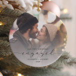 First Christmas Engaged Custom Photo Gray Script Ceramic Ornament<br><div class="desc">Commemorate your engagement with this beautiful modern keepsake ornament. The charcoal gray text reads "Our first Christmas engaged, " with the word "engaged" in elegant script with swashes before and after. Replace the sample image with your favorite photo, and add your names and the year. A white gradient filter helps...</div>