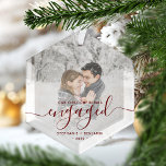 First Christmas Engaged Custom Photo Red Script Glass Ornament<br><div class="desc">Commemorate your engagement with this beautiful modern keepsake ornament. The dark red text reads "Our first Christmas engaged, " with the word "engaged" in elegant handwriting script with flourishes before and after. Replace the sample image with your favorite photo, and add your names and the year. A white gradient filter...</div>