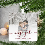 First Christmas Engaged Custom Photo Red Script Metal Ornament<br><div class="desc">Commemorate your engagement with this beautiful modern keepsake ornament. The dark red text reads "Our first Christmas engaged, " with the word "engaged" in elegant handwriting script with flourishes before and after. Replace the sample image with your favorite photo, and add your names and the year. A white gradient filter...</div>