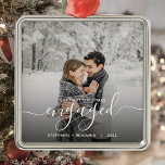 First Christmas Engaged Custom Photo White Script Metal Ornament<br><div class="desc">Commemorate your engagement with this beautiful modern keepsake ornament. The white text reads "Our first Christmas engaged, " with the word "engaged" in elegant handwriting script with flourishes before and after. Replace the sample image with your favorite photo, and add your names and the year. A black gradient filter helps...</div>