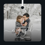 First Christmas Engaged Custom Photo White Script Metal Ornament<br><div class="desc">Commemorate your engagement with this beautiful modern keepsake ornament. The white text reads "Our first Christmas engaged, " with the word "engaged" in elegant handwriting script with flourishes before and after. Replace the sample image with your favorite photo, and add your names and the year. A dark gradient filter helps...</div>