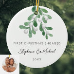 First Christmas Engaged Mistletoe Photo Ceramic Ornament<br><div class="desc">Celebrate your first Christmas as an engaged couple with this stylish photo ceramic ornament. 
It is decorated with watercolor mistletoe and elegant script typography.
Easily customizable with your names,  date,  and photo.
Use the Design Tool to change the text size,  style,  or color.
Original Watercolor © Michele Davies.</div>