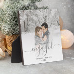 First Christmas Engaged Photo Silver Script Plaque<br><div class="desc">Commemorate your engagement with this beautiful modern keepsake plaque. The text reads "Our first Christmas engaged, " with the word "engaged" in elegant silver faux foil handwriting script with flourishes before and after. Replace the sample image with your favorite photo, and add your names and the year. A white gradient...</div>
