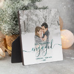 First Christmas Engaged Photo Teal Blue Script Plaque<br><div class="desc">Commemorate your engagement with this beautiful modern keepsake plaque. The teal blue text reads "Our first Christmas engaged, " with the word "engaged" in elegant faux foil handwriting script with flourishes before and after. Replace the sample image with your favorite photo, and add your names and the year. A white...</div>