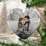 First Christmas Engaged Photo White Script Heart Ornament<br><div class="desc">Commemorate your engagement with this beautiful heart-shaped keepsake ornament. The white text reads "Our first Christmas engaged, " with the word "engaged" in elegant handwriting script with flourishes before and after. Replace the sample image with your favorite photo, and add your names and the year. A black gradient filter helps...</div>