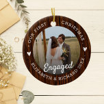 First Christmas Engaged Rustic Faux Wood 2 Photo Ceramic Ornament<br><div class="desc">Celebrate the magic of your First Christmas Engaged with this Rustic Faux Wood 2 Photo Ornament, designed to capture the special moments of your After Engagement Christmas. This charming ornament features a Faux Wood backdrop that adds a cozy, rustic touch to your holiday decor. Perfect for a Couple First Christmas,...</div>