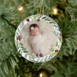 First Christmas Green Holiday Wreath Baby Photo Ceramic Ornament<br><div class="desc">This elegant two-sided holiday photo keepsake ornament features a newborn photo of your baby girl framed by a floral watercolor holiday greenery wreath. The back of the ornament includes "First Christmas" wording with custom text that can be personalized with the baby's full name and the year of their birth. Includes...</div>