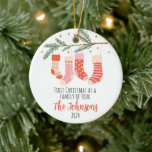 First Christmas of Four Custom Family Ceramic Orna Ceramic Ornament<br><div class="desc">Commemorate the "First Christmas of a Family of Four" with this personalized ornament,  showcasing charming stockings and holiday accents. Customize with your family name to create a memorable keepsake celebrating this special milestone. It is a delightful addition to your Christmas tree and a treasured holiday memory.</div>