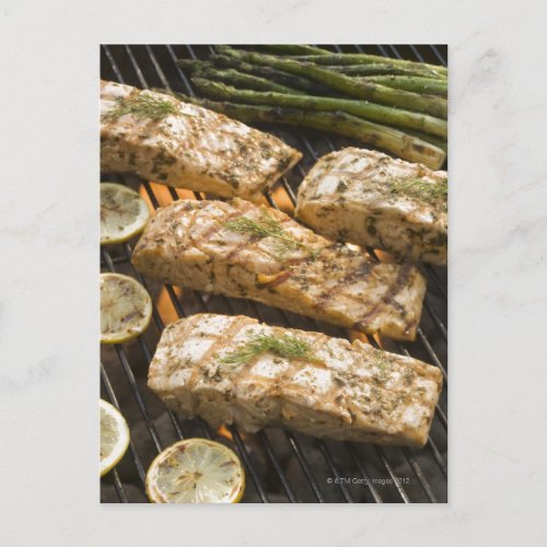 Fish and asparagus cooking on grill postcard