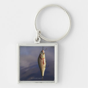 fishing lure in front of water keychain