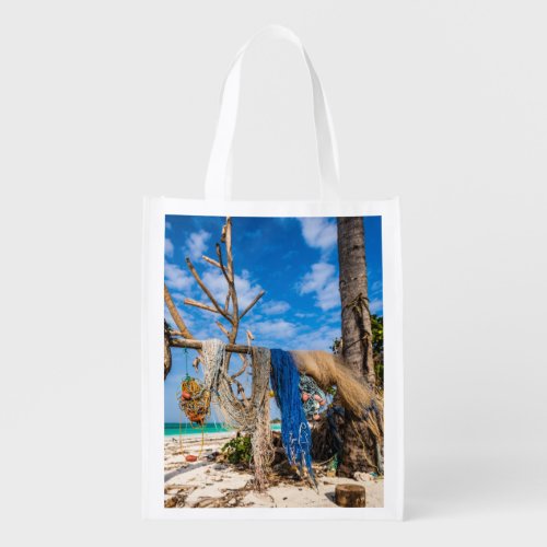 Fishing nets drying on the beach grocery bag