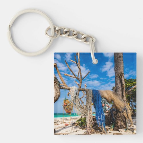 Fishing nets drying on the beach keychain