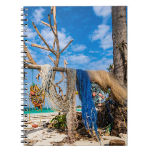 Fishing nets drying on the beach notebook