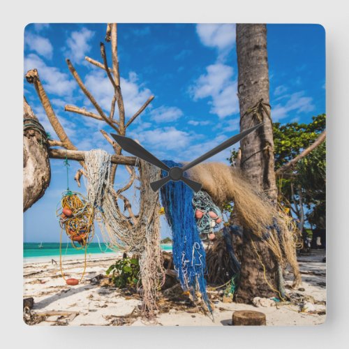 Fishing nets drying on the beach square wall clock