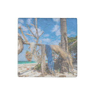 Fishing nets drying on the beach stone magnet