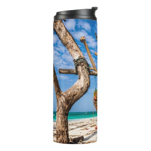 Fishing nets drying on the beach thermal tumbler