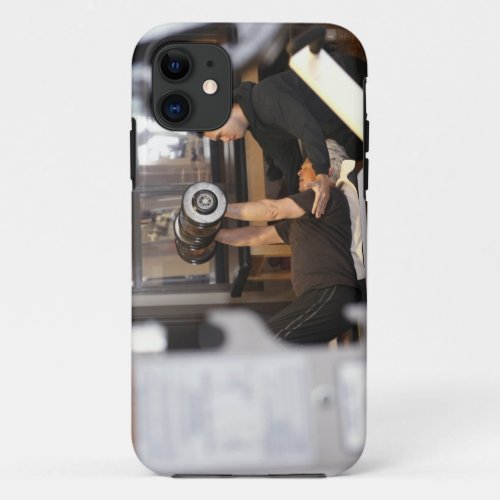 fitness coach works with senior in gym iPhone 11 case