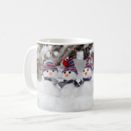 Five cute snowmen dressed for winter coffee mug