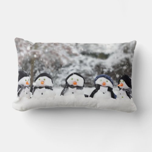 Five cute snowmen facing forward lumbar pillow