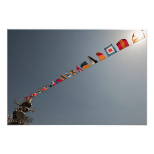 Flags fly over the deck of the USS Iwo Jima Photo Print