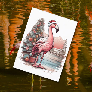 Flamingo wearing santa hat beside Christmas tree Postcard