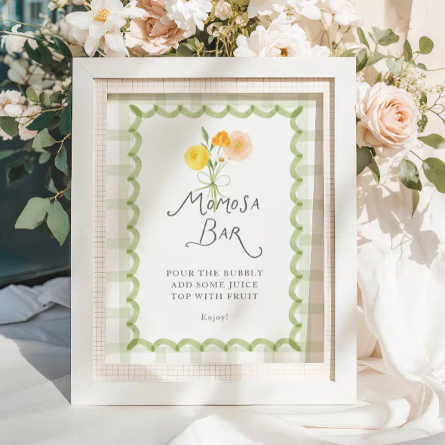 A framed print is placed in front of a vase filled with baby pink roses, white wild roses, and eucalyptus, to direct baby shower guests to the beverage bar.