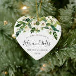Floral Mr. and Mrs. Photo Our First Christmas Ceramic Ornament<br><div class="desc">Did you get married this year? Add a memory to your tree with this elegant floral keepsake ceramic ornament featuring a top border comprised of hand painted white roses and greenery and the message, "Our First Christmas as Mr. and Mrs." in a lovely handwritten script font. Use the template to...</div>