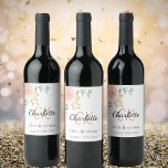 Floral rose gold monogram birthday party wine label<br><div class="desc">For an elegant 50th (or any age) birthday party.  White background.  Decorated with a rose gold rose and eucalyptus greenery.  Personalize and add a name and monogram initials and the date. The name is written with a modern hand lettered style script.  Black and golden letters.</div>