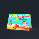 Florida Merry Christmas Santa and Flamingo Beach Holiday Card<br><div class="desc">This Merry Christmas holiday greeting card features Santa Clause at a Florida Beach. He is relaxing enjoying the sun, palm trees, his pipe and a funny pink flamingo wearing a Santa hat and wreath. Inside Greeting ~ "Warmest Wishes from our Holiday Paradise to yours... ". All of the text, on...</div>