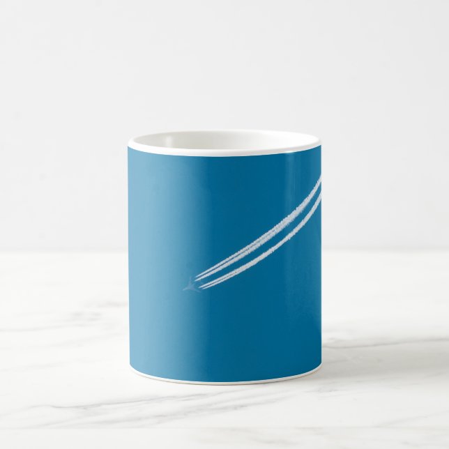 Flying airplane on a blue sky background coffee mug (Center)