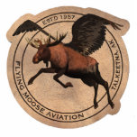 Flying Moose Aviation Patch Cutout<br><div class="desc">A leather patch bearing the logo of mythical Flying Moose Aviation in Talkeetna, Alaska as worn by the company's bush pilots. Features a winged moose superimposed on a circle with text reading "FLYING MOOSE AVIATION, " "TALKEETNA, AK" and "ESTD 1957." Flightseeing, glacier landings, cargo, hunting and fishing charters. We fly,...</div>